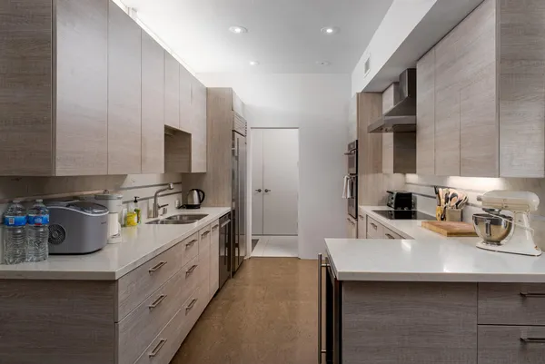 a kitchen that has a sink cabinets counter space and a window