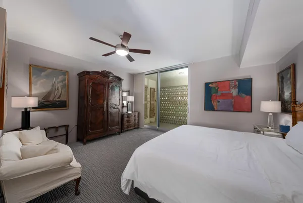 a bedroom with a bed and a view of walk in closet