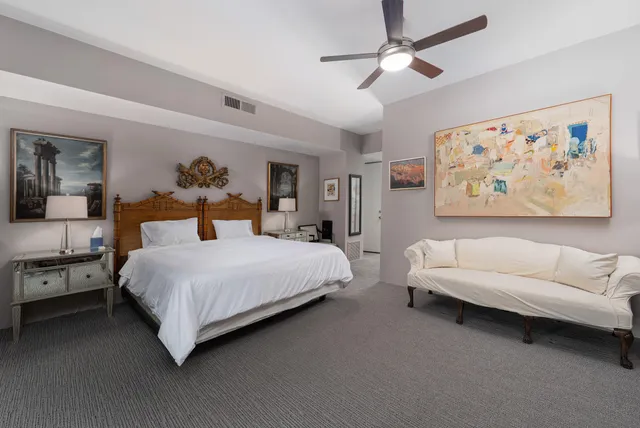 a view of a room that has a bed and a view of bedroom