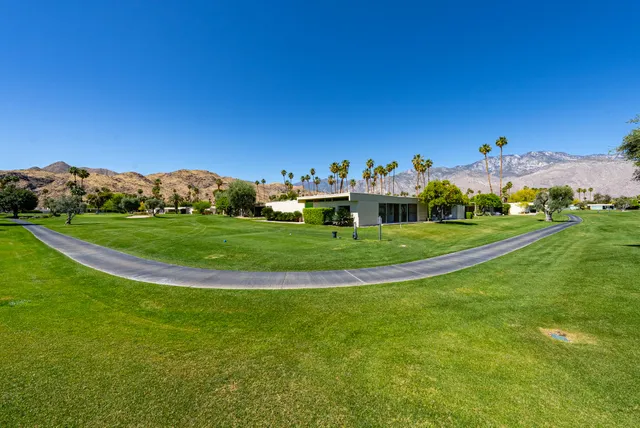 a view of a water with a fountain in front of the house