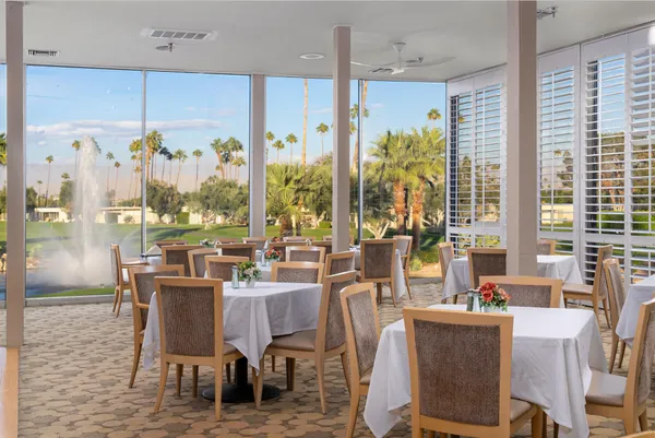 a dining area with a table and chairs