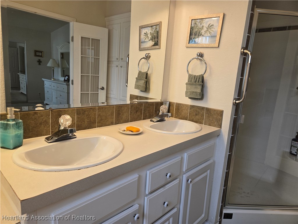 3312 Beartooth Pass Sebring, FL 33872 - Photo 25 of 39 a bathroom with a sink and a mirror