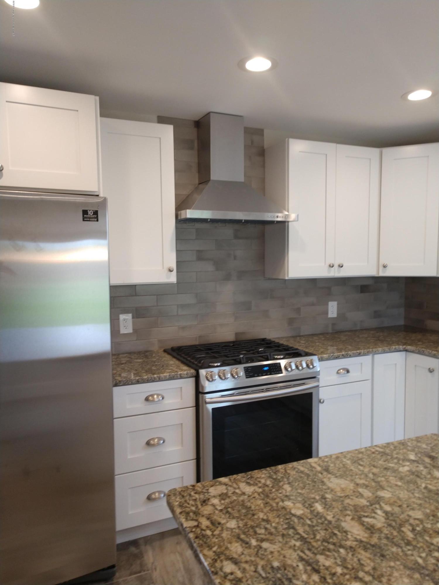 4373 State Rte 2014 Forest City, PA 18421 - Photo 11 of 32 a kitchen with a stove and white cabinets