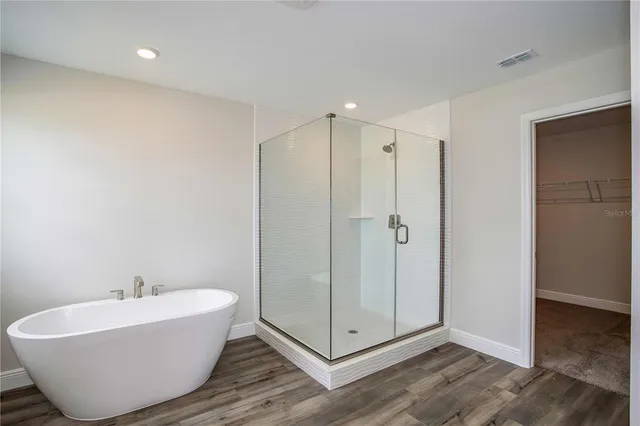 a bathroom with a bathtub and shower