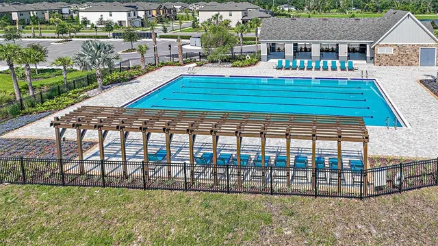 an aerial view of a residential houses with outdoor space
