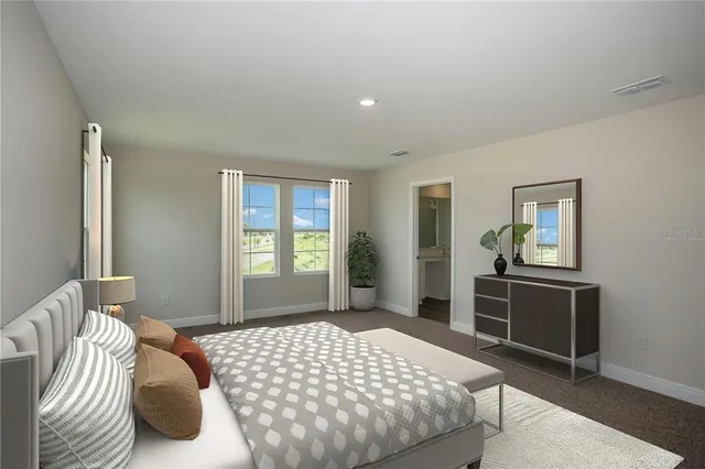 a bedroom with a bed and dresser with mirror