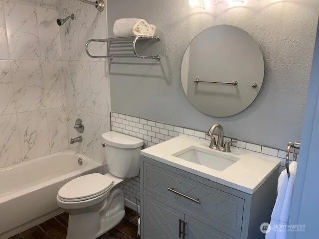 a bathroom with a sink a toilet and a mirror