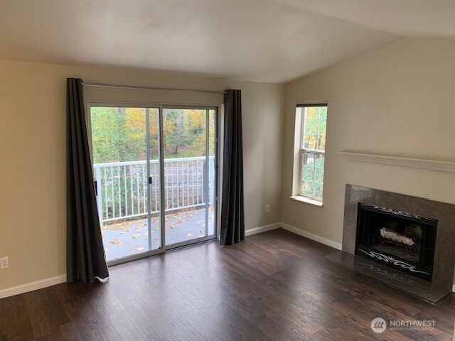 7453 Newcastle Golf Club Road, Unit A304 Newcastle, WA 98059 - Photo 7 of 19 a view of an empty room with wooden floor and a window