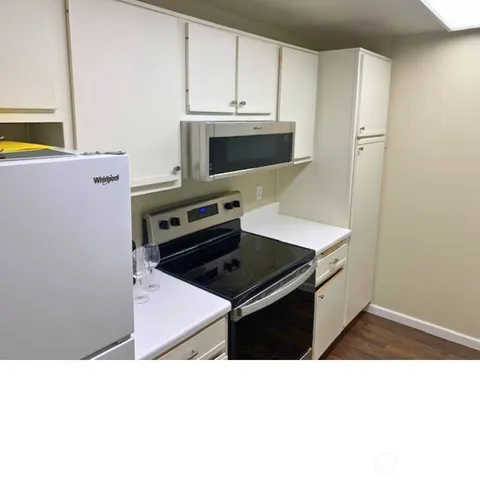a kitchen with a sink stove and microwave