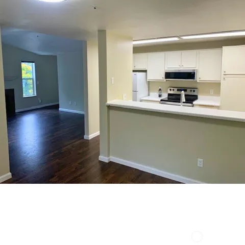 a kitchen with a sink a microwave and cabinets