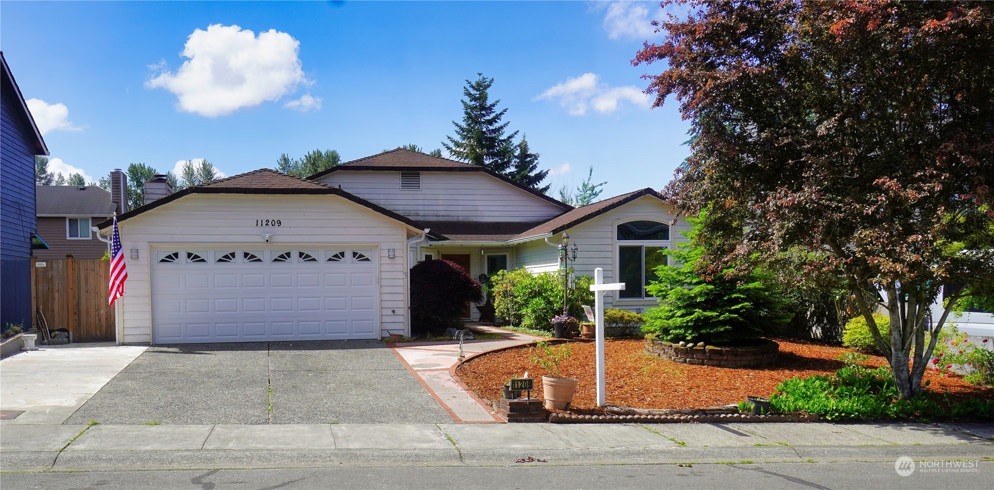 a front view of a house with garden