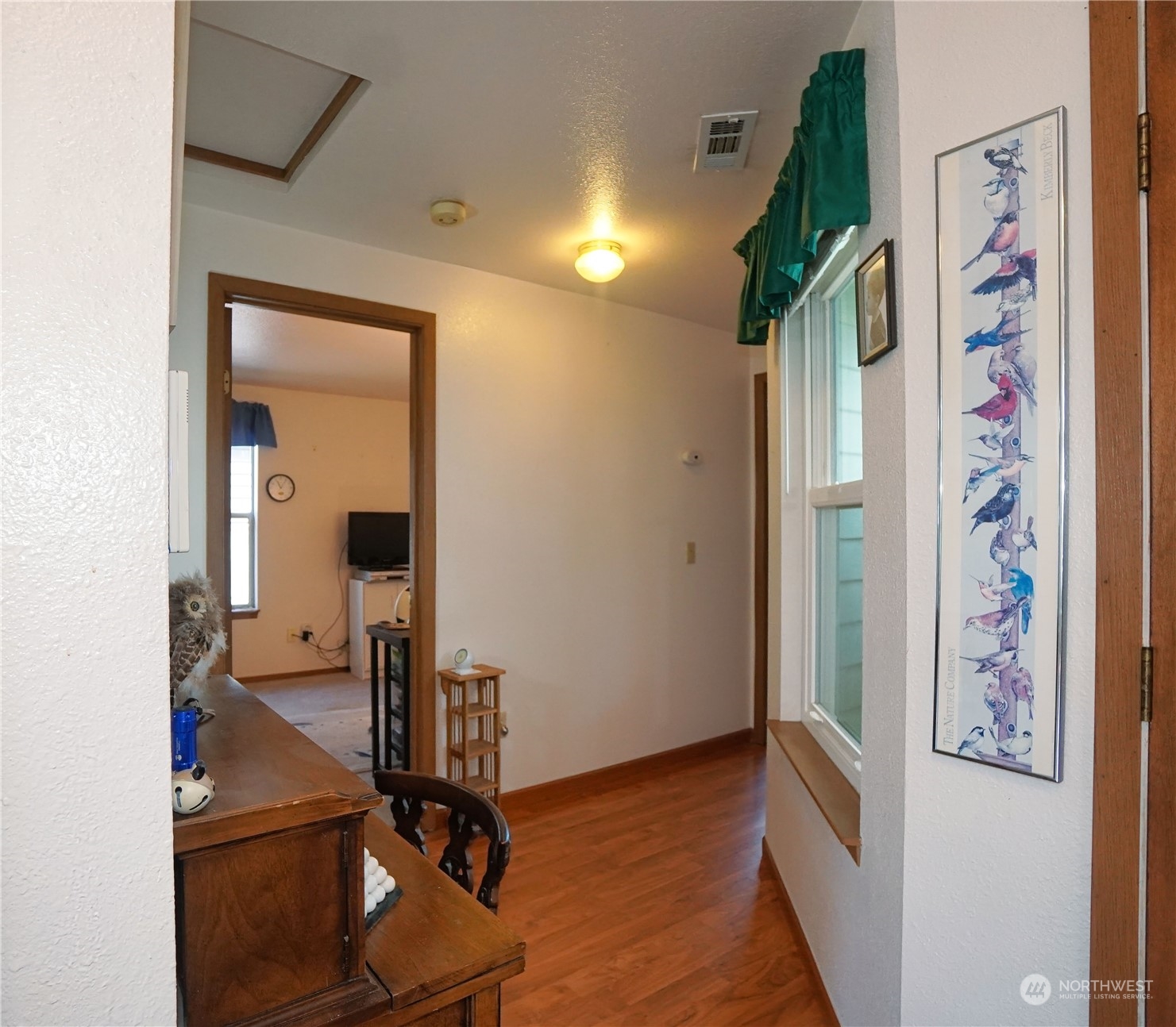 11209 Southeast 267th Place Kent, WA 98030 - Photo 12 of 31 a view of a hallway with paintings on the wall
