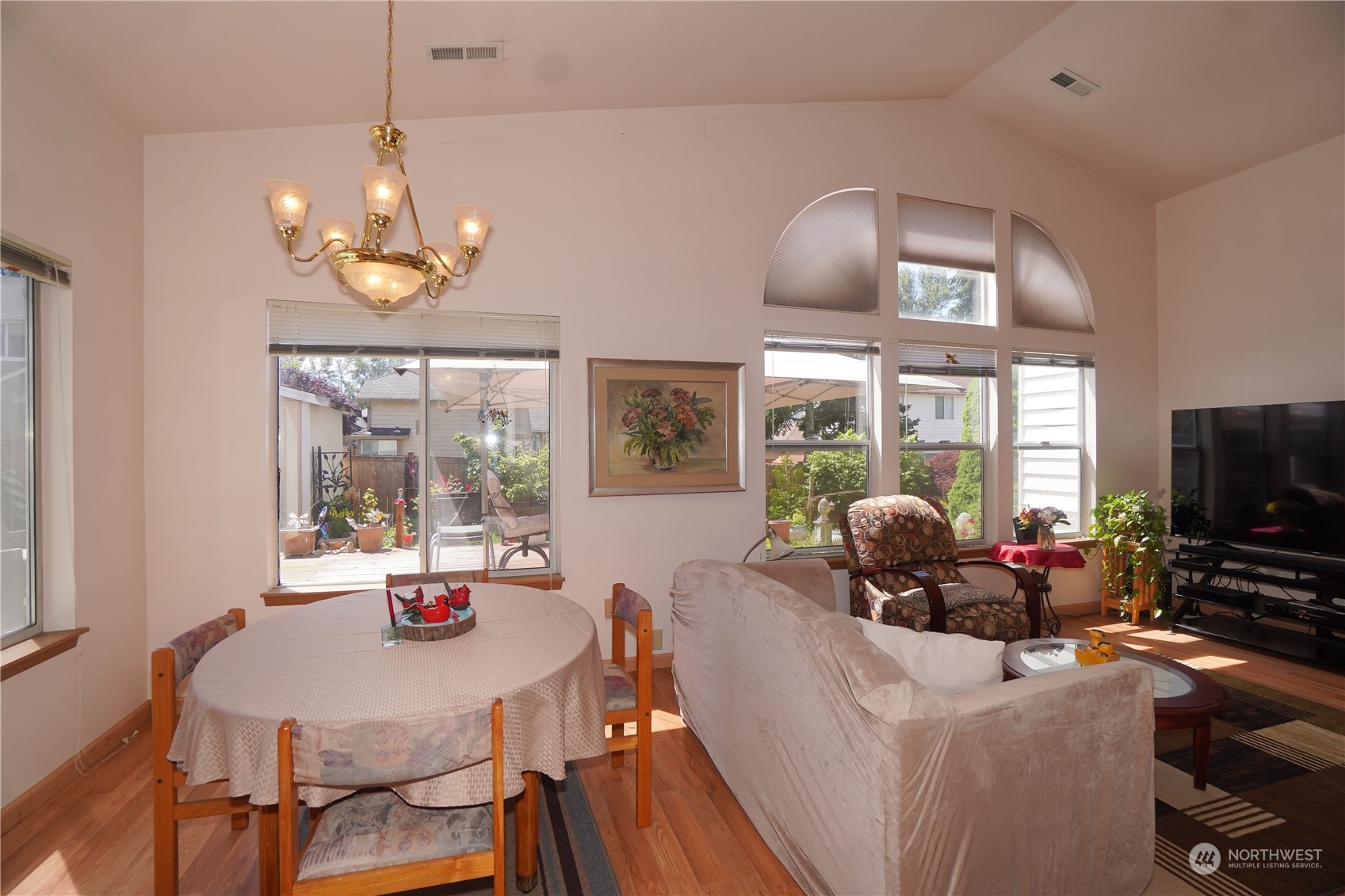 11209 Southeast 267th Place Kent, WA 98030 - Photo 6 of 31 a view of a dining room with furniture a chandelier and large windows