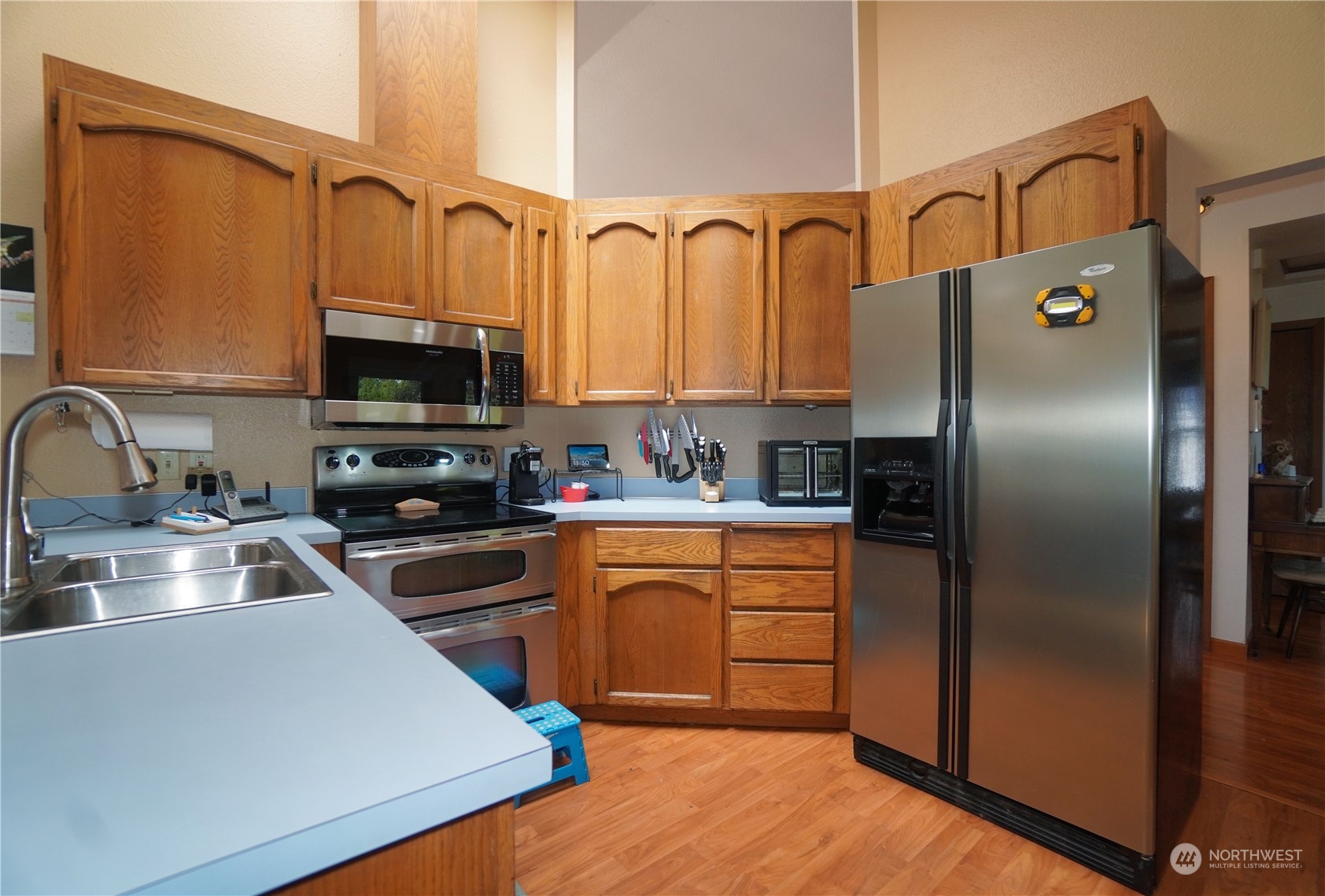 11209 Southeast 267th Place Kent, WA 98030 - Photo 8 of 31 a kitchen with stainless steel appliances granite countertop a refrigerator a stove top oven a sink and dishwasher
