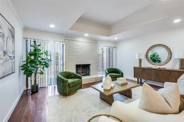 a living room with furniture potted plant and a fireplace