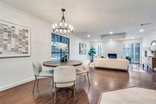 a view of a dining room with furniture wooden floor and chandelier