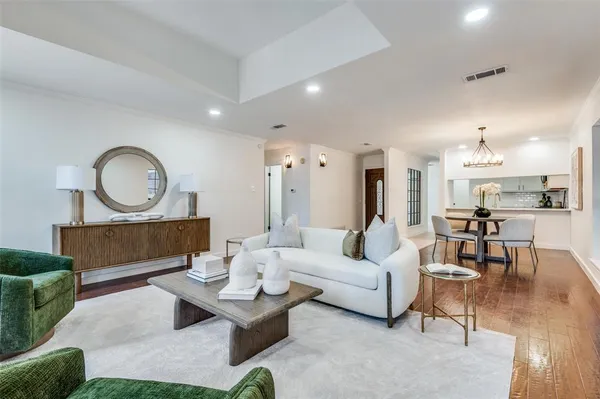 a living room with furniture a mirror and a table