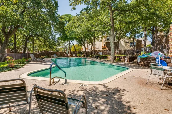 a view of a swimming pool with a patio