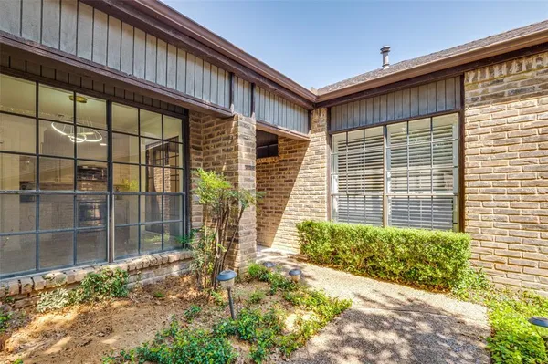 a front view of a house with a large window