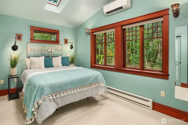 a bed sitting in a bedroom next to a bathroom