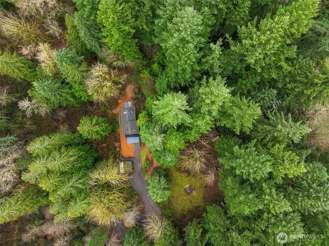 a view of house with yard and sitting area