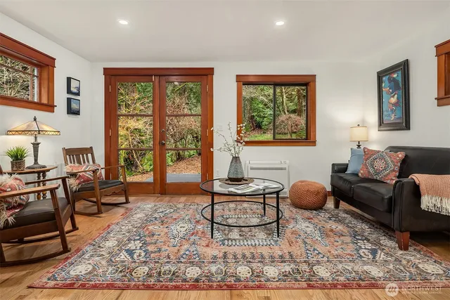 a living room with furniture a rug and a large window