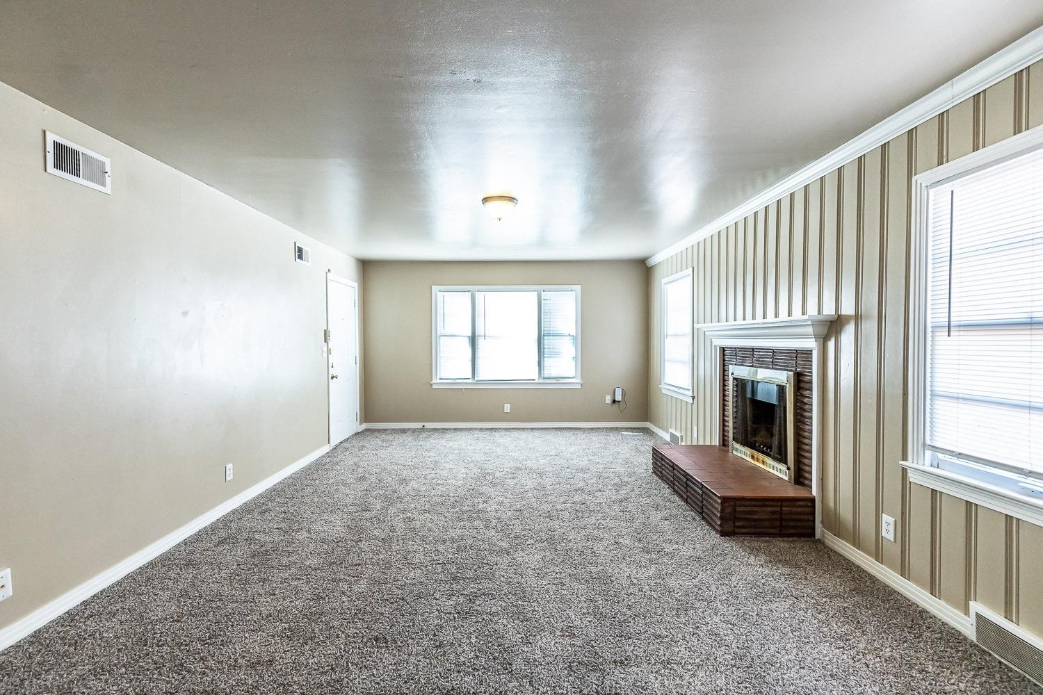 3708 27th Street Lubbock, TX 79410 - Photo 3 of 23 a view of a livingroom with a fireplace and window