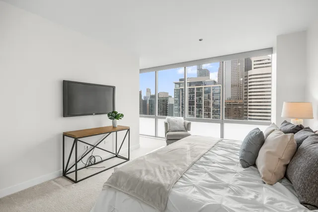 a bedroom with a bed and a painting on the wall