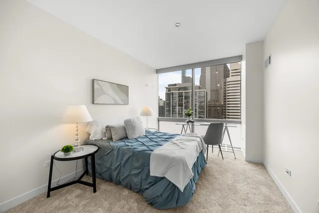 a bedroom with a bed and a chair