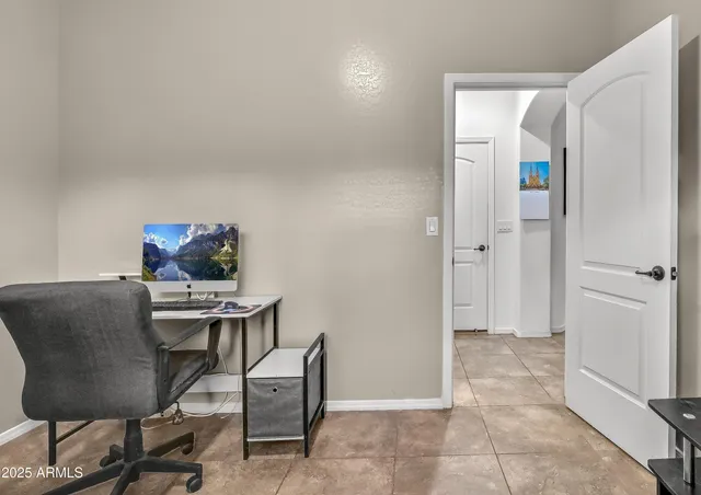 a view of a workspace with furniture and wooden floor
