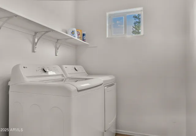 a view of a big house with a street and trees in the background