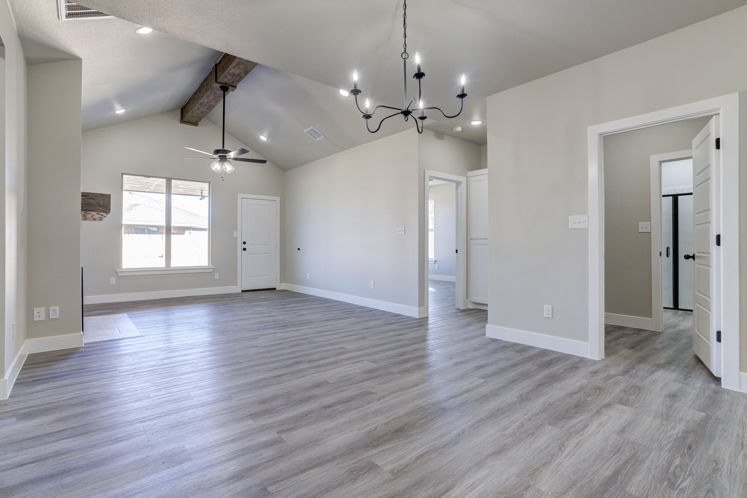 6928 12th Street Lubbock, TX 79416 - Photo 14 of 50 wooden floor in an empty room with a window