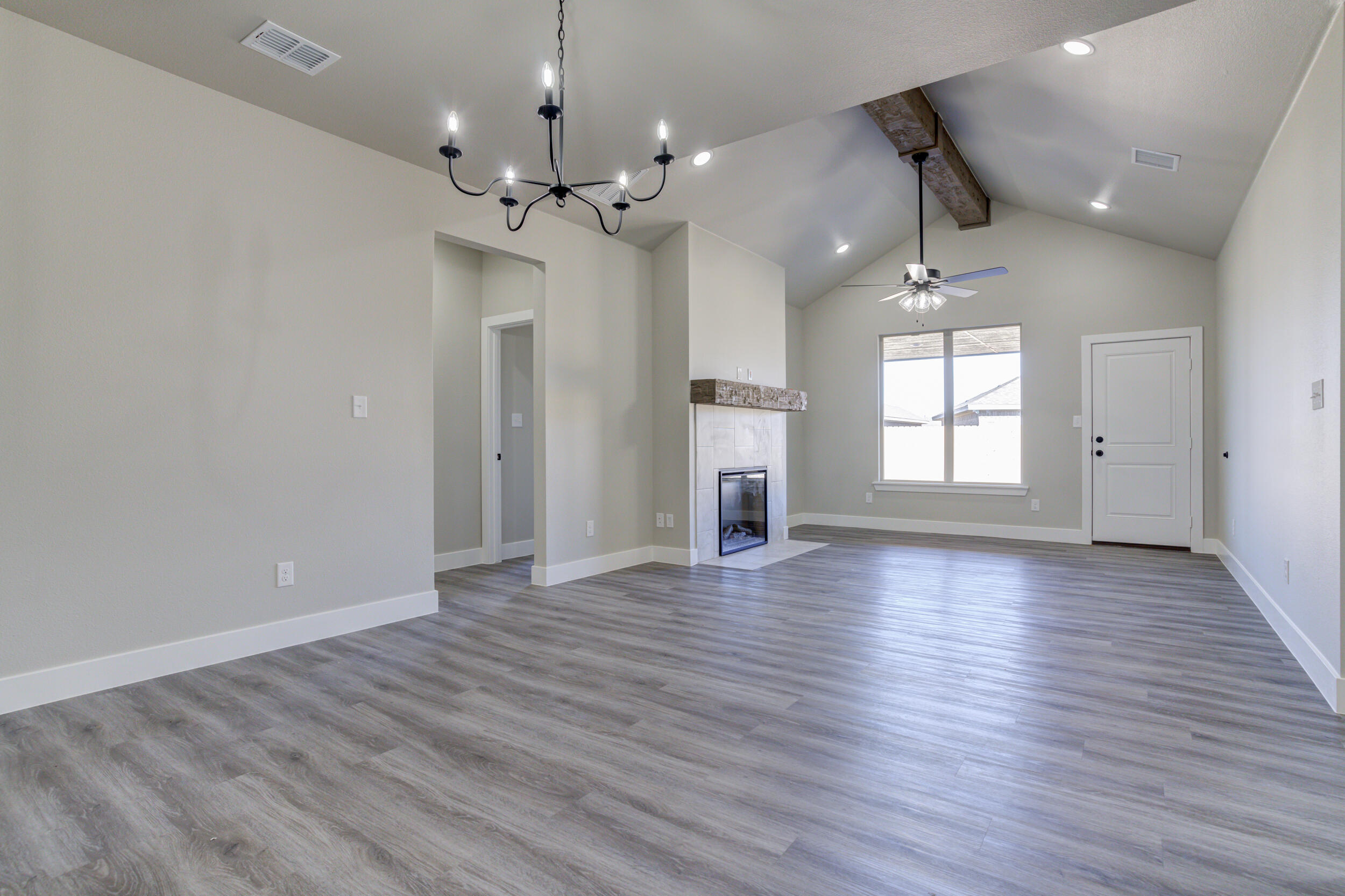 6928 12th Street Lubbock, TX 79416 - Photo 15 of 50 an empty room with wooden floor and windows