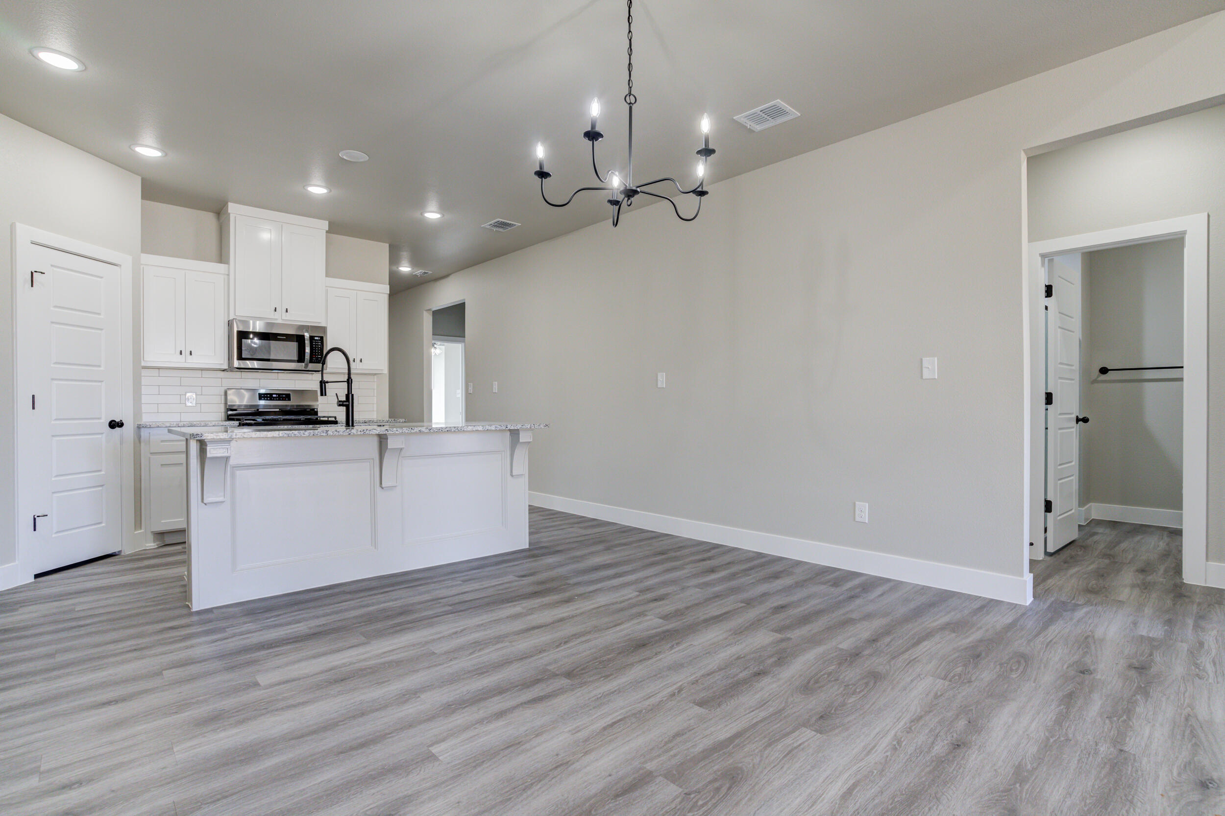 6928 12th Street Lubbock, TX 79416 - Photo 16 of 50 a view of kitchen with granite countertop cabinets and stainless steel appliances