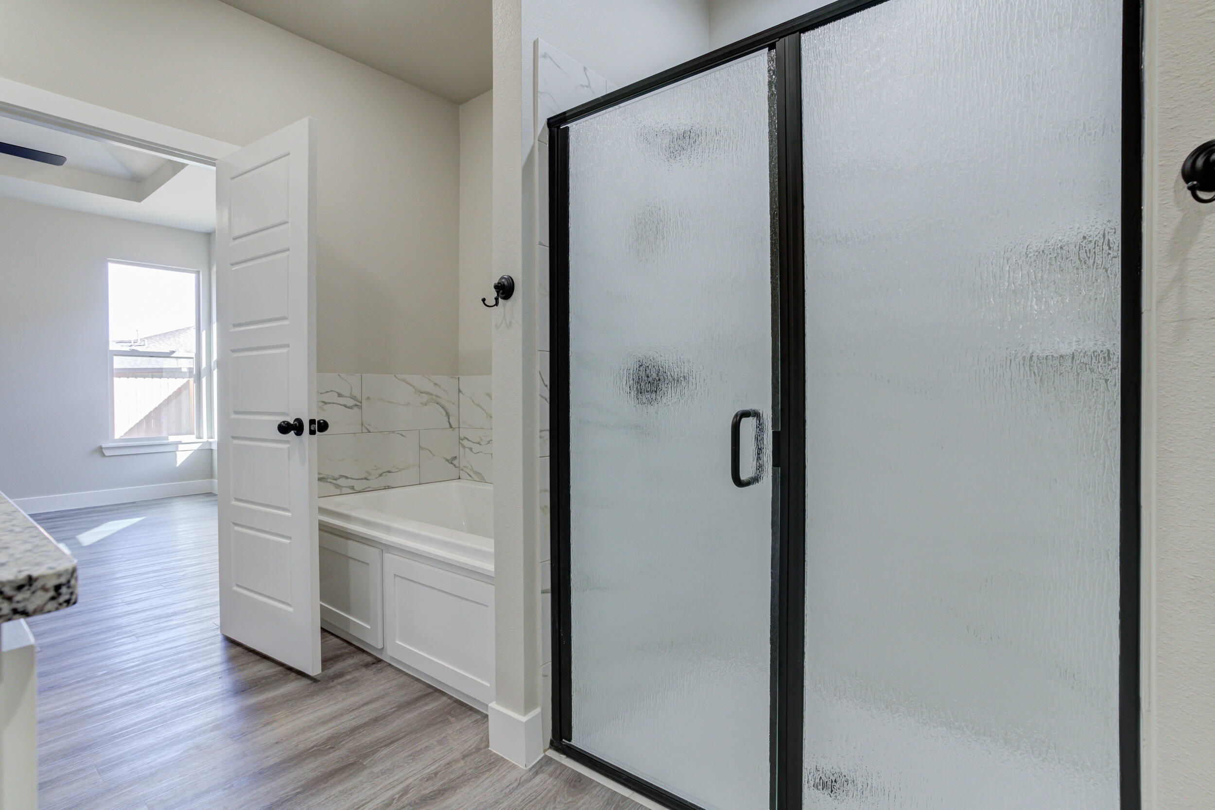 6928 12th Street Lubbock, TX 79416 - Photo 31 of 50 a bathroom with a bathtub a shower a toilet and a sink
