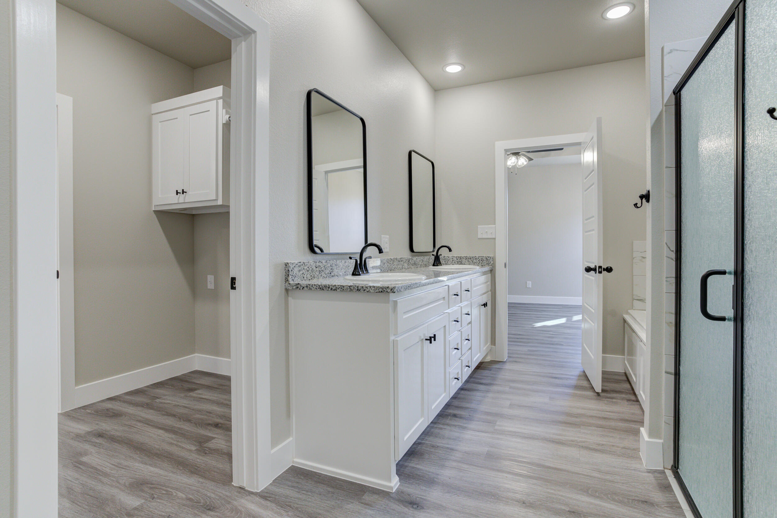 6928 12th Street Lubbock, TX 79416 - Photo 33 of 50 a bathroom with 2 sink and a mirror