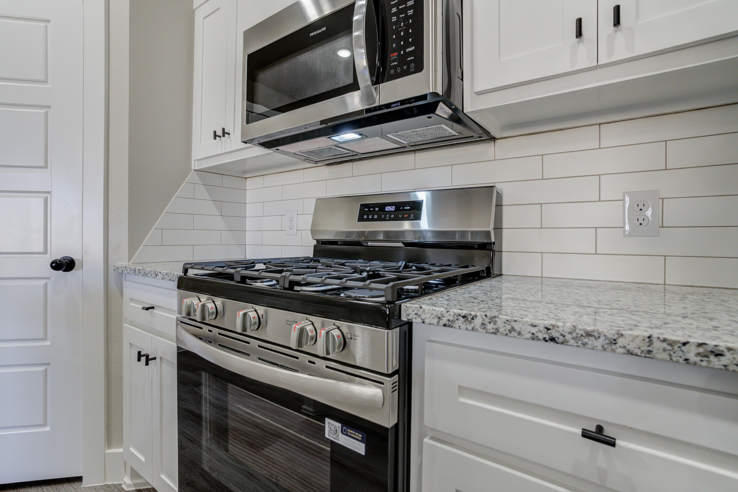6928 12th Street Lubbock, TX 79416 - Photo 8 of 50 a kitchen with a stove and a microwave