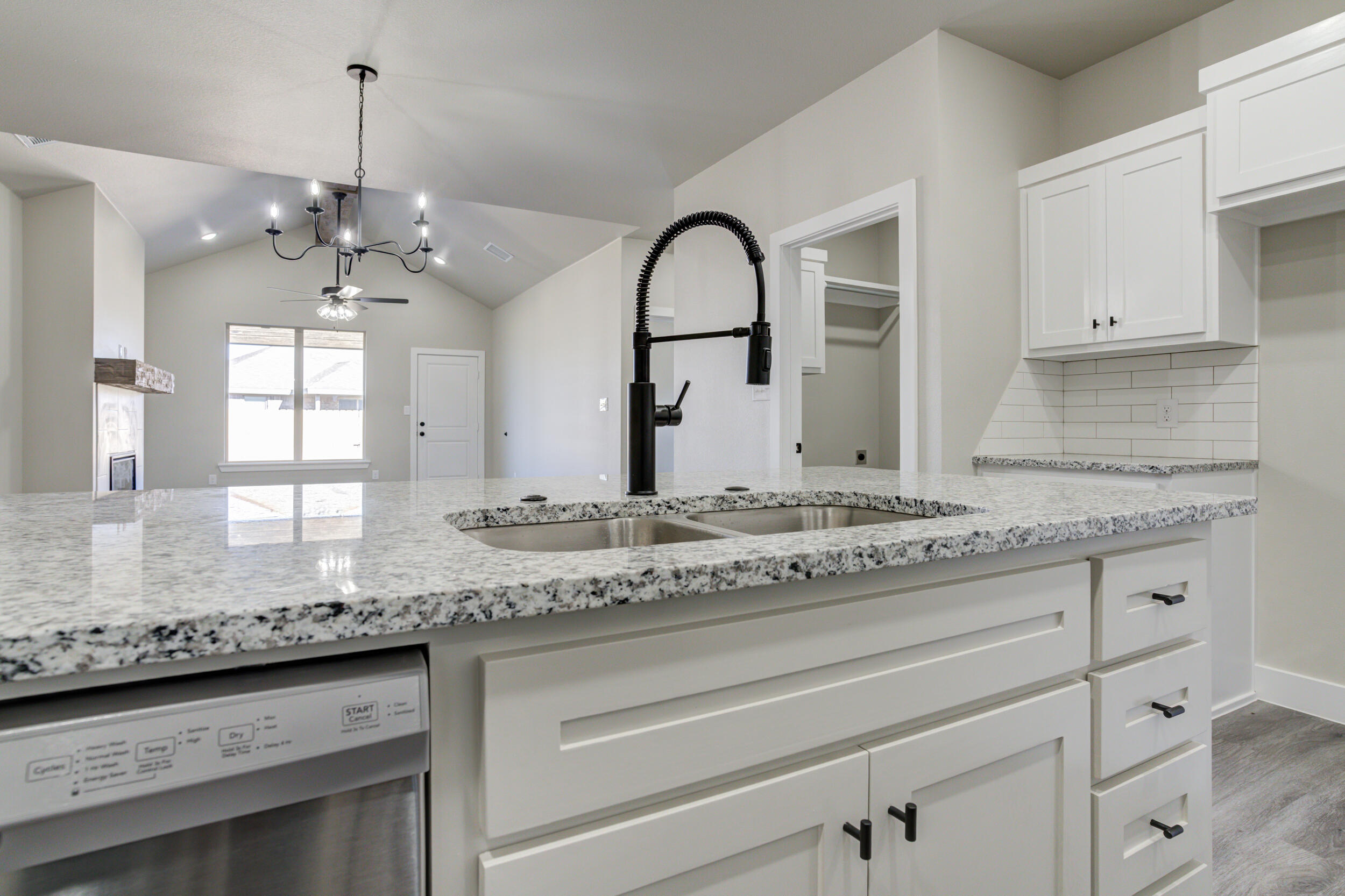 6928 12th Street Lubbock, TX 79416 - Photo 9 of 50 a bathroom with a granite countertop sink a large mirror and cabinets