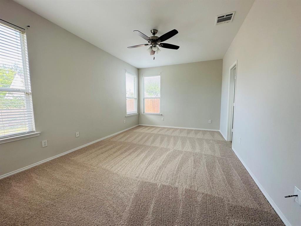 9701 Meadow Rue Drive McKinney, TX 75072 - Photo 13 of 24 wooden floor in an empty room with a window