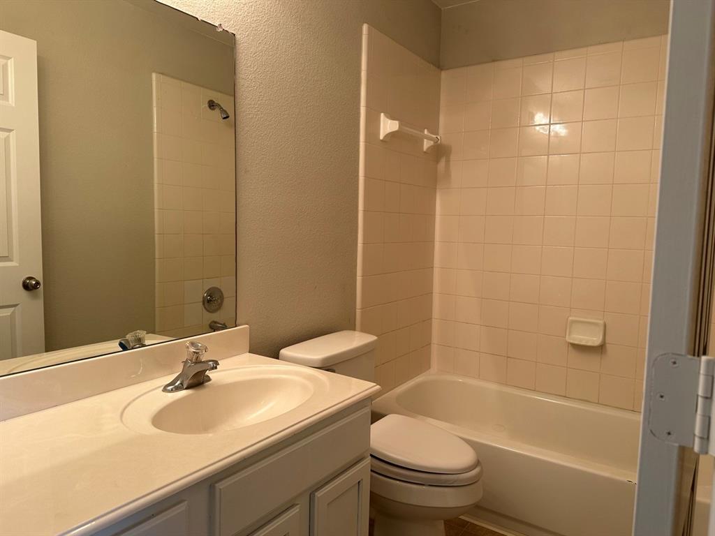 9701 Meadow Rue Drive McKinney, TX 75072 - Photo 22 of 24 a bathroom with a sink toilet and shower