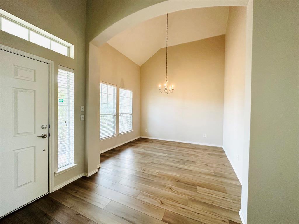 9701 Meadow Rue Drive McKinney, TX 75072 - Photo 3 of 24 a view of an empty room with wooden floor and a window