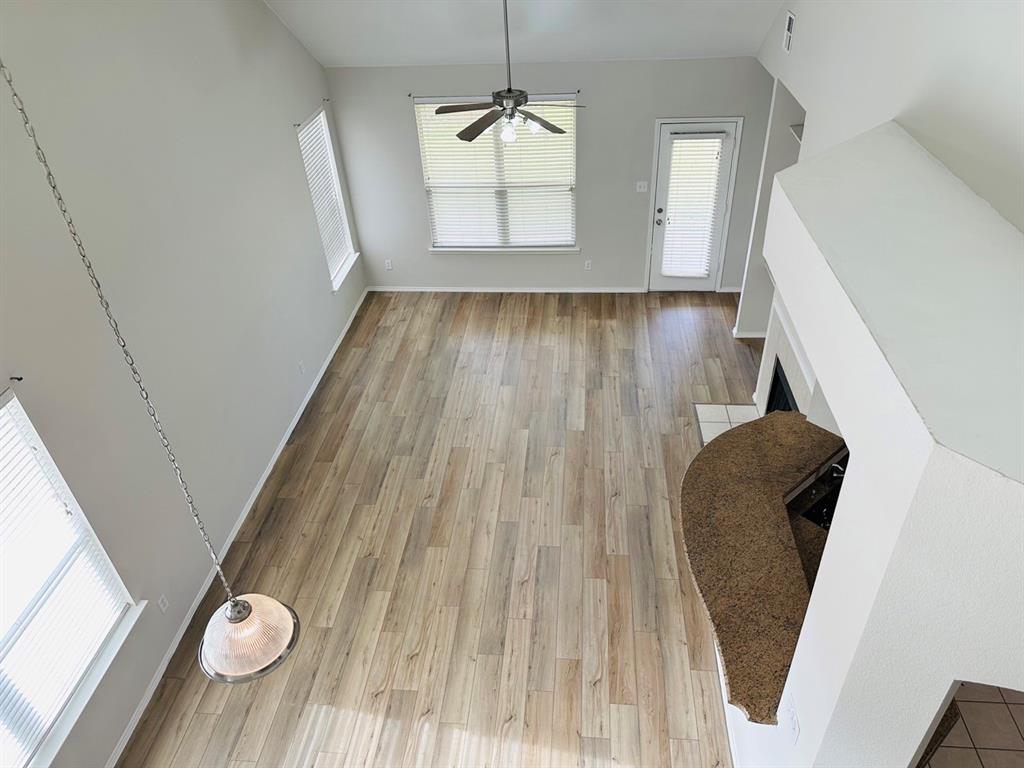9701 Meadow Rue Drive McKinney, TX 75072 - Photo 7 of 24 a view of a living room with wooden floor and windows