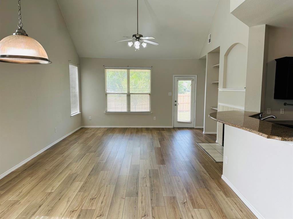 9701 Meadow Rue Drive McKinney, TX 75072 - Photo 8 of 24 a view of a livingroom with wooden floor and a window
