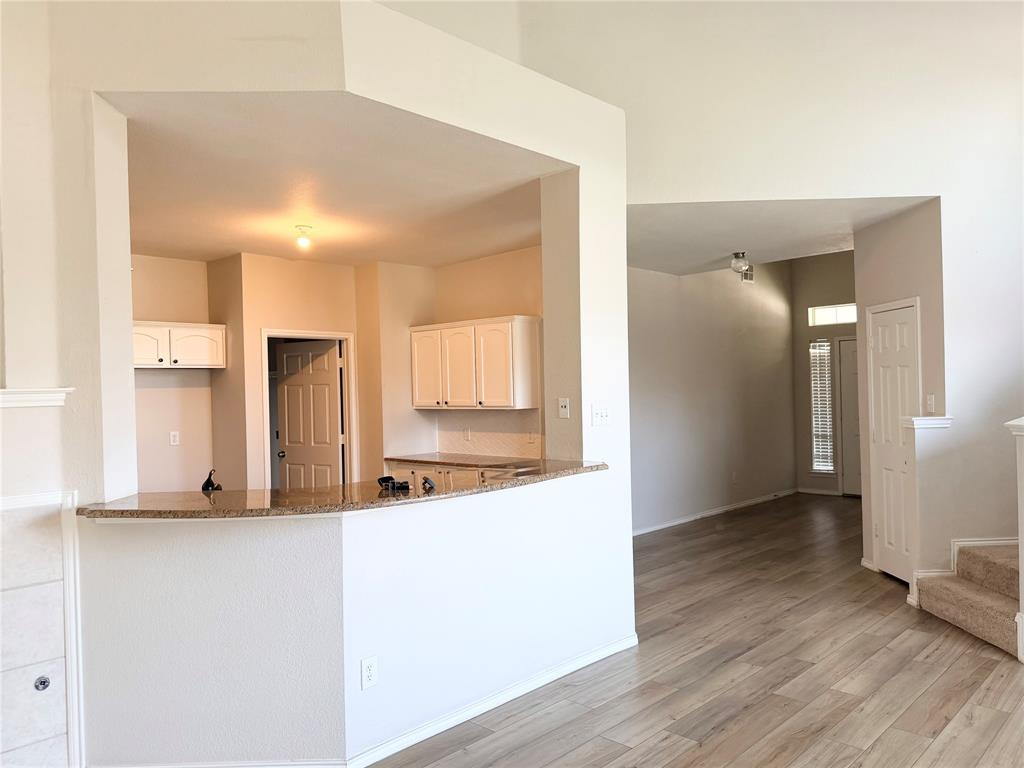9701 Meadow Rue Drive McKinney, TX 75072 - Photo 9 of 24 a view of a kitchen cabinets and wooden floor