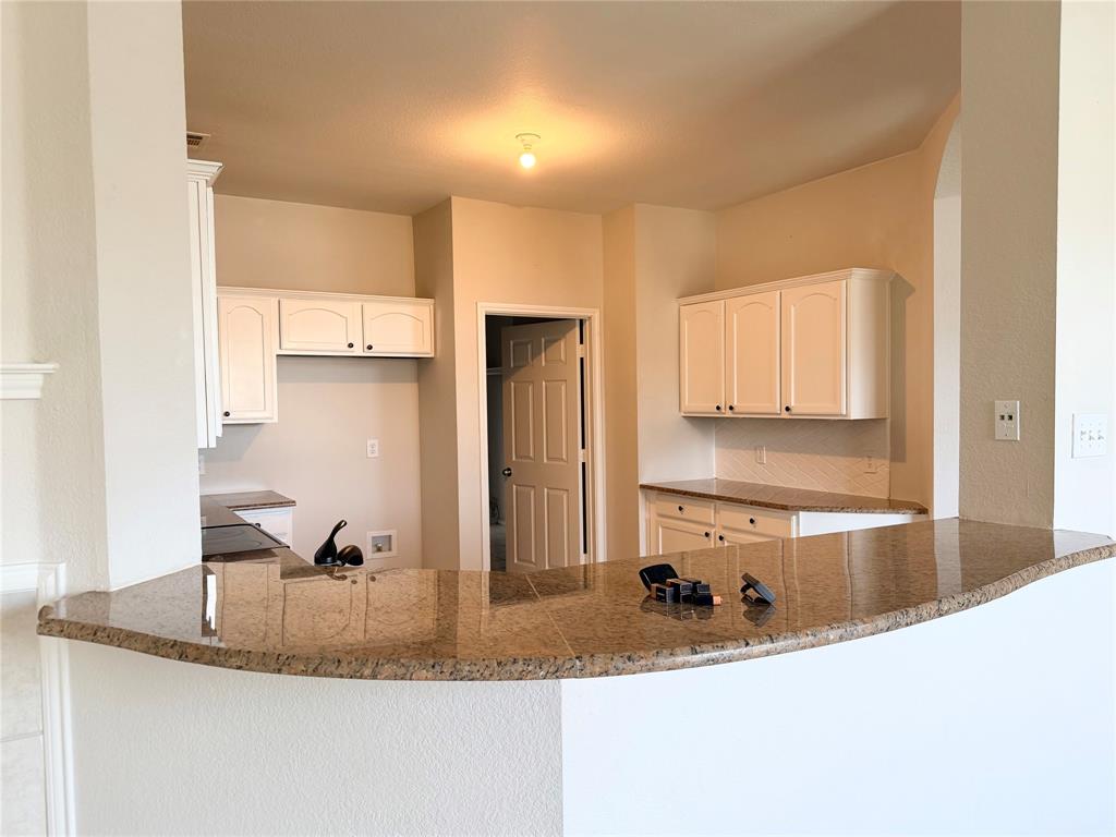9701 Meadow Rue Drive McKinney, TX 75072 - Photo 10 of 24 a kitchen with stainless steel appliances granite countertop a sink a stove and a refrigerator
