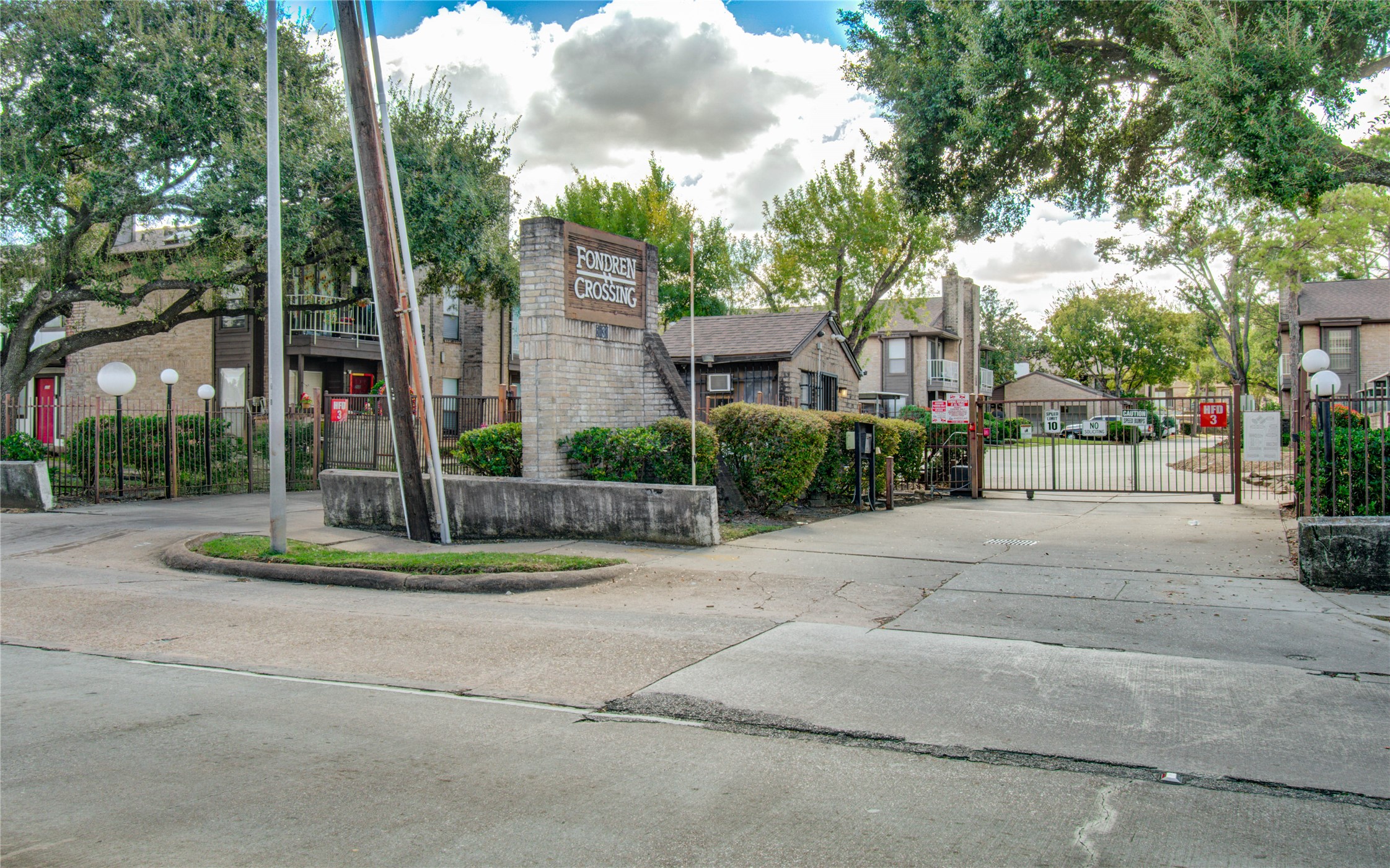 6633 West Airport Boulevard, Unit 1008 Houston, TX 77035 - Photo 8 of 8 a view of a white house with a big yard and large trees