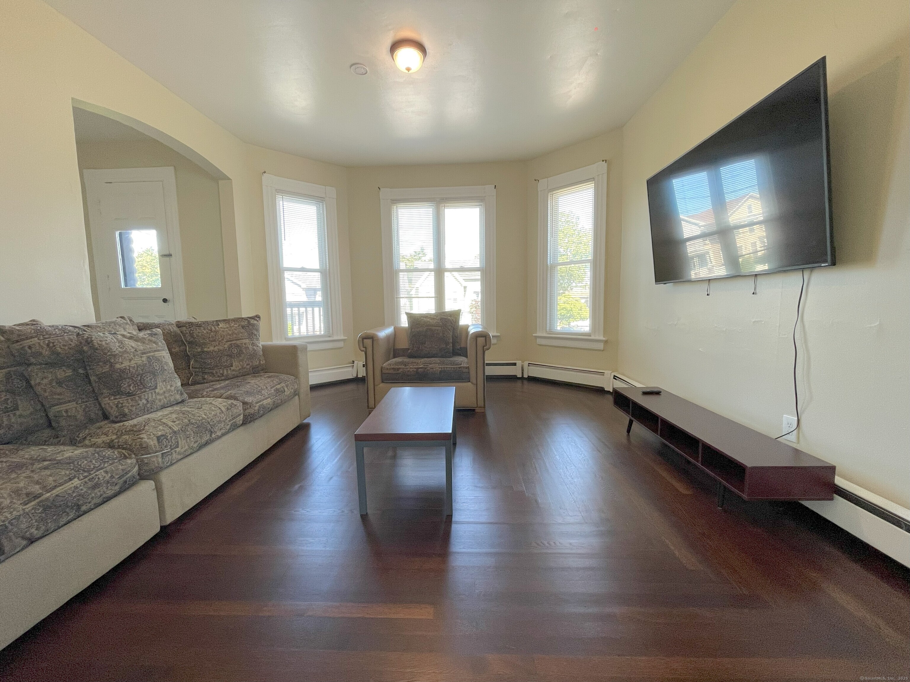 196 Blatchley Avenue, Unit 2 New Haven, CT 06513 - Photo 1 of 7 a living room with couches and a flat screen tv with wooden floor