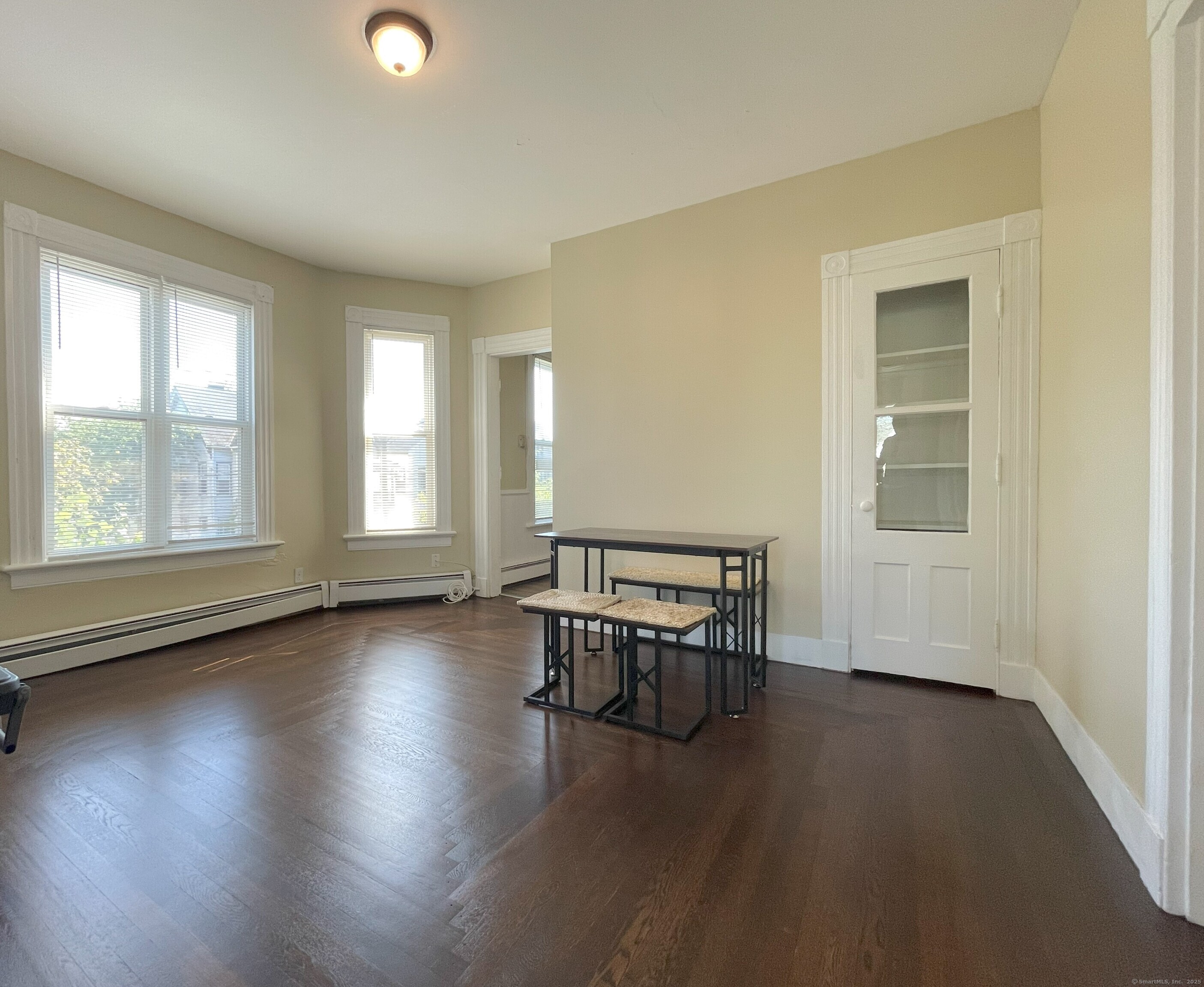 196 Blatchley Avenue, Unit 2 New Haven, CT 06513 - Photo 2 of 7 an empty room with wooden floor and windows