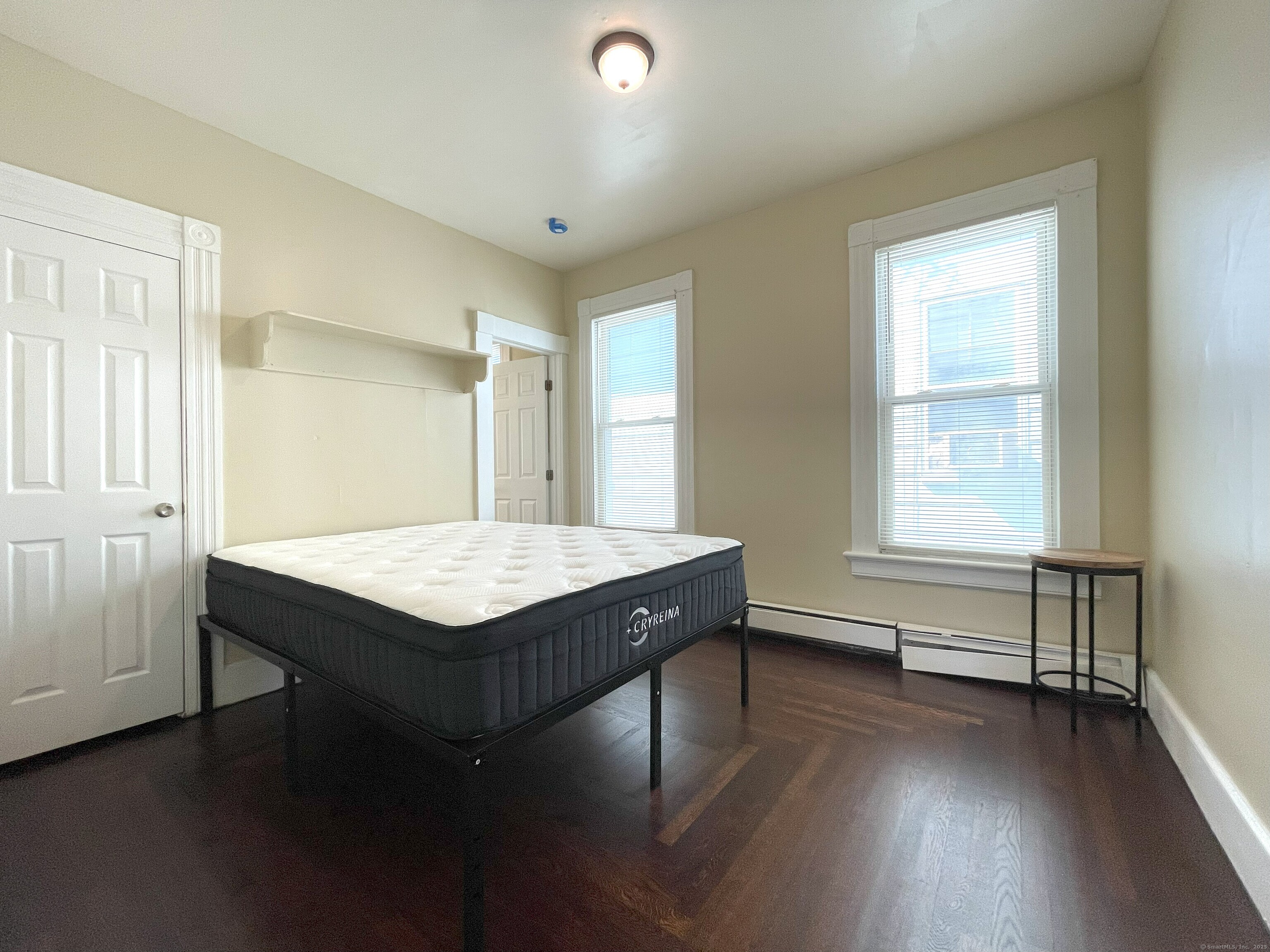 196 Blatchley Avenue, Unit 2 New Haven, CT 06513 - Photo 5 of 7 an empty room with wooden floor and windows