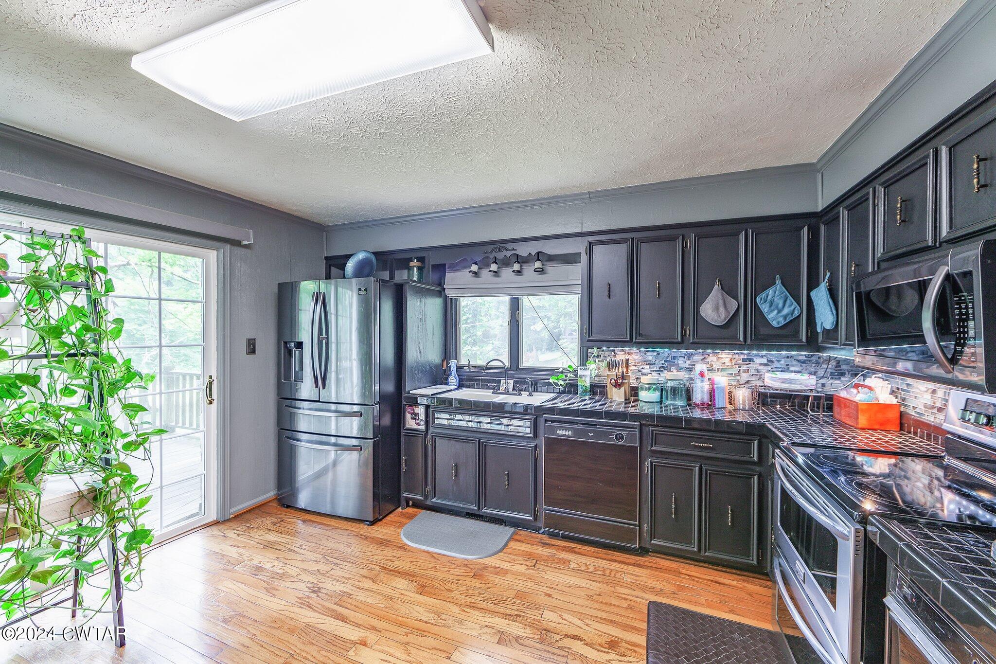 93 Lohrig Road Jackson, TN 38301 - Photo 12 of 27 a kitchen with stainless steel appliances granite countertop a stove a sink dishwasher and a refrigerator